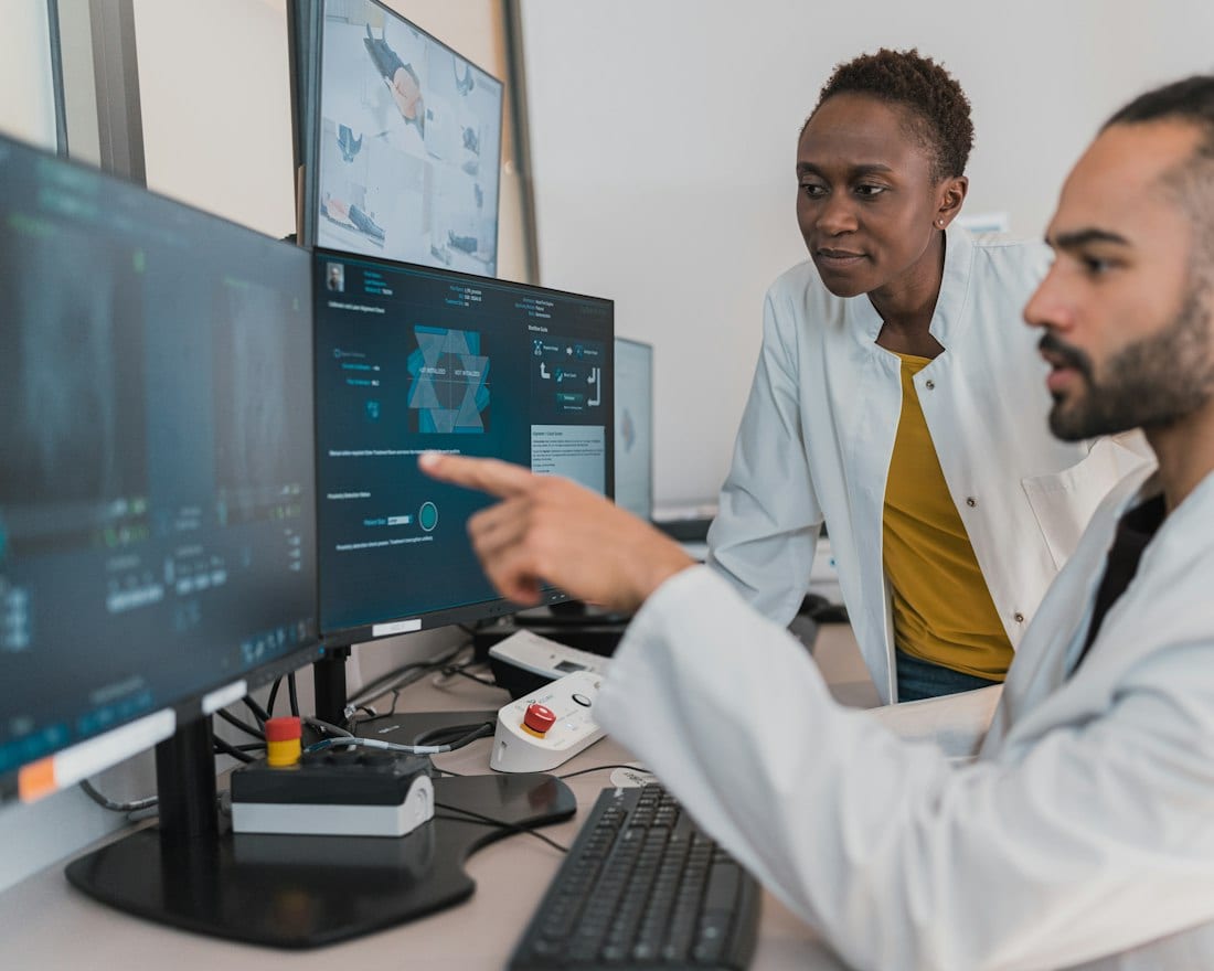 Clinicians reviewing medical imaging data on a workstation
